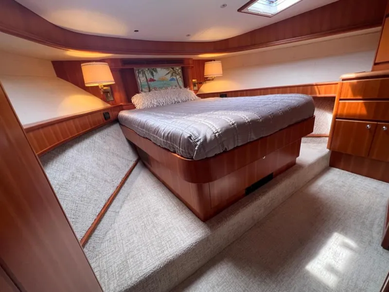 Slide: The Image of Luxurious bedroom interior of 2003 West Bay 68 yacht with wood paneling and cozy lighting. - 19