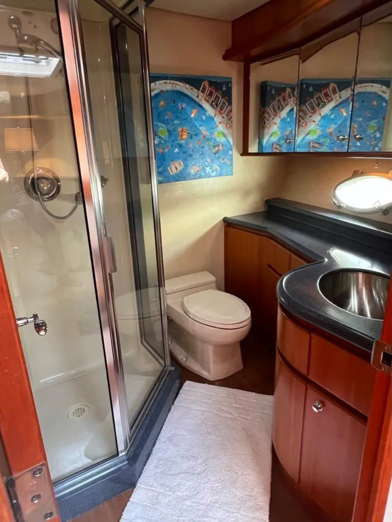 Slide: The Image of Luxurious bathroom in 2003 West Bay 68 yacht with shower, sink, and modern decor. - 20