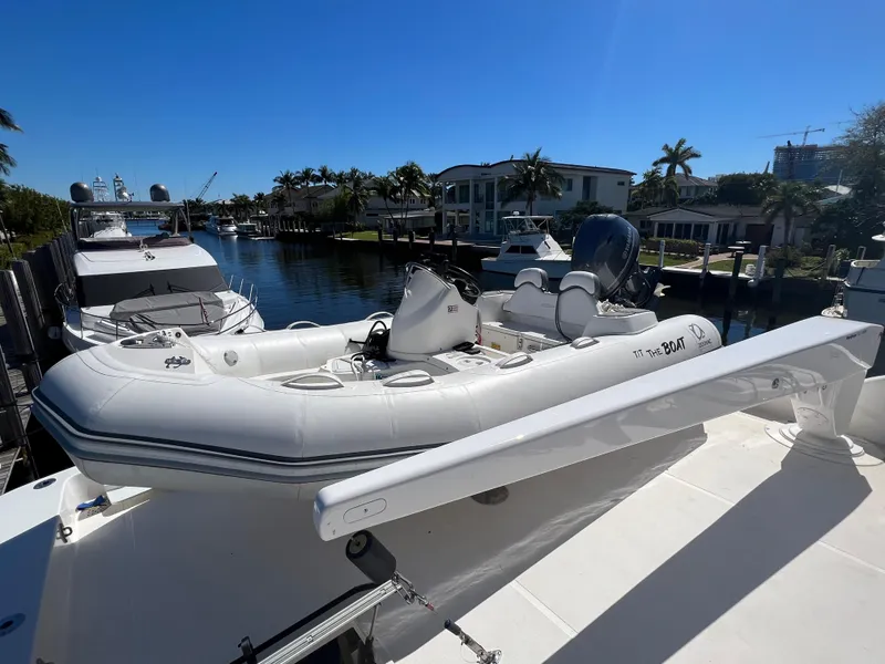 Slide: The Image of White inflatable boat on a West Bay 68 yacht, docked in a sunny marina. - 25