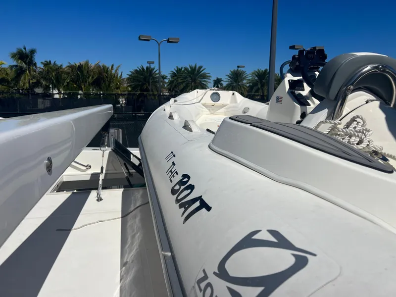 Slide: The Image of 2003 West Bay 68 yacht with inflatable boat on deck, under clear blue sky. - 26