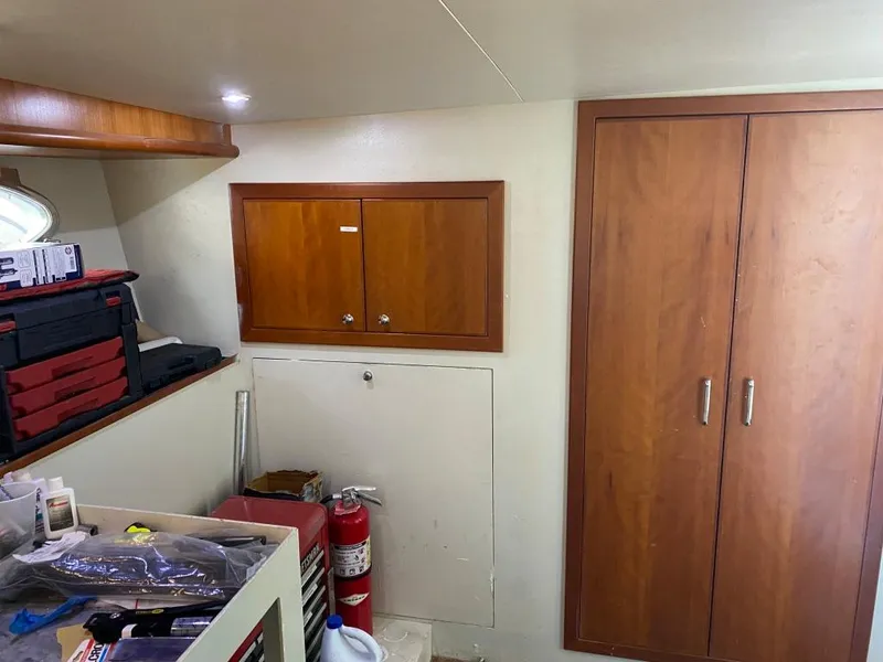 Slide: The Image of Interior of 2003 West Bay 68 yacht with wooden cabinets and storage area. - 29