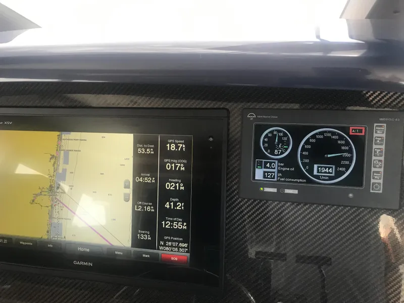 Slide: The Image of Dashboard of a 2003 West Bay 68 yacht with navigation and engine displays. - 32