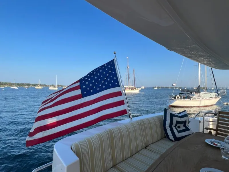 Slide: The Image of American flag on a 2003 West Bay 68 yacht, with scenic ocean view. - 5