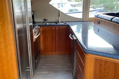 Slide: The Image of Luxurious kitchen interior of 2003 West Bay 68 yacht with wood cabinetry and modern appliances. - 9