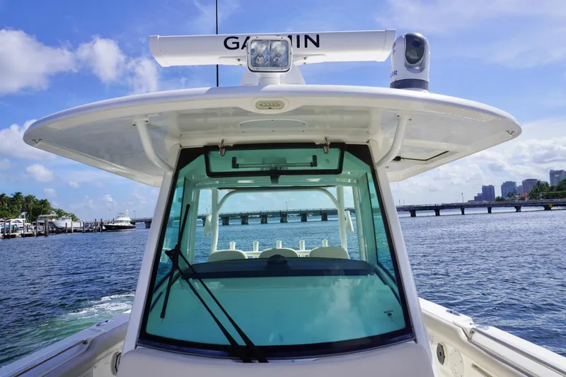 Slide: The Image of Boston Whaler 350 Outrage 2020 model on water with bridge in background. - 13