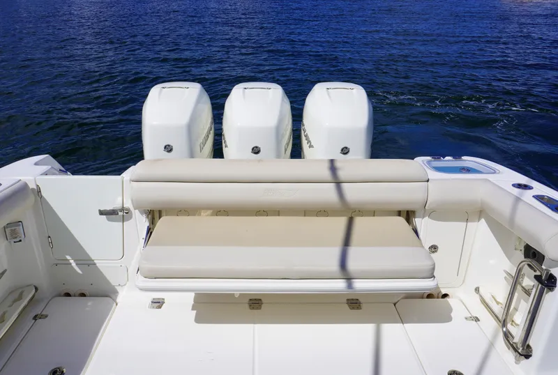 Slide: The Image of Boston Whaler 350 Outrage 2020 boat with triple outboard engines and cushioned seating. - 14