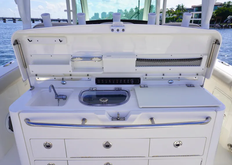 Slide: The Image of 2020 Boston Whaler 350 Outrage boat cockpit with sink, storage, and prep station. - 18