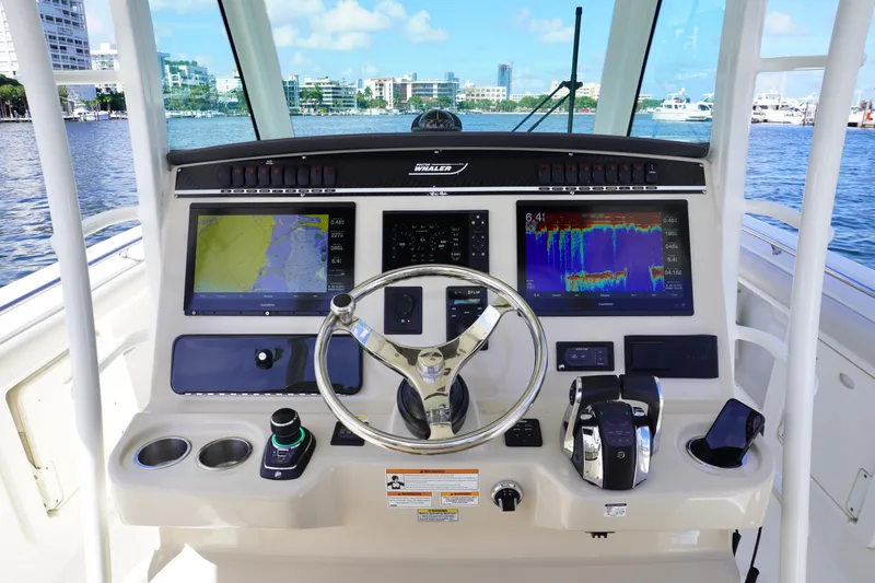 Slide: The Image of 2020 Boston Whaler 350 Outrage helm with navigation screens and controls. - 6