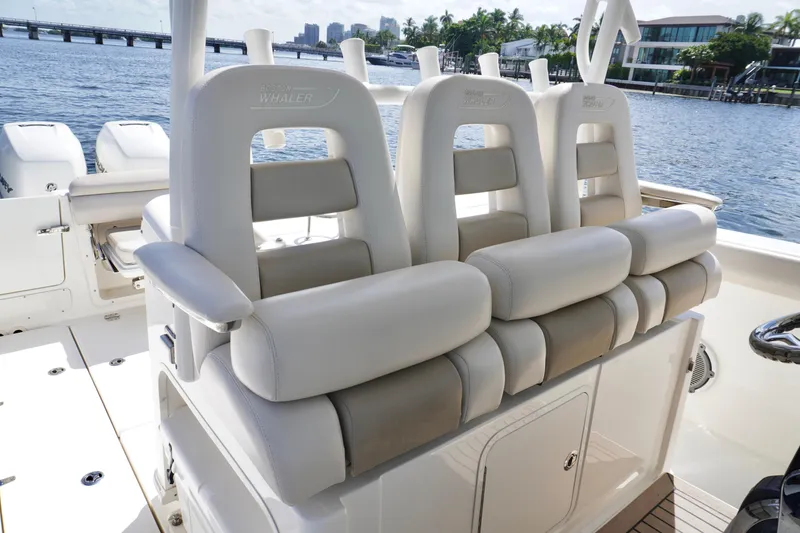 Slide: The Image of 2020 Boston Whaler 350 Outrage boat seating with waterfront view. - 7