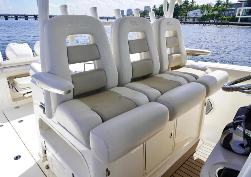 Slide: The Image of Boston Whaler 350 Outrage 2020 model, luxurious seating on a boat with waterfront view. - 8