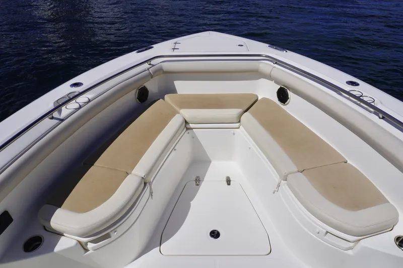 Slide: The Image of Bow seating area of 2020 Boston Whaler 350 Outrage boat with beige cushions. - 9