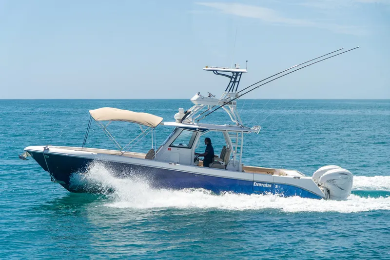 Slide: The Image of 2019 Everglades 355 Center Console boat cruising on the ocean. - 12