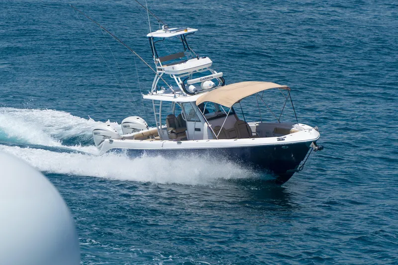 Slide: The Image of 2019 Everglades 355 Center Console boat cruising on open water. - 3