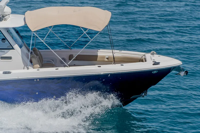 Slide: The Image of 2019 Everglades 355 Center Console boat cruising on blue ocean water. - 4