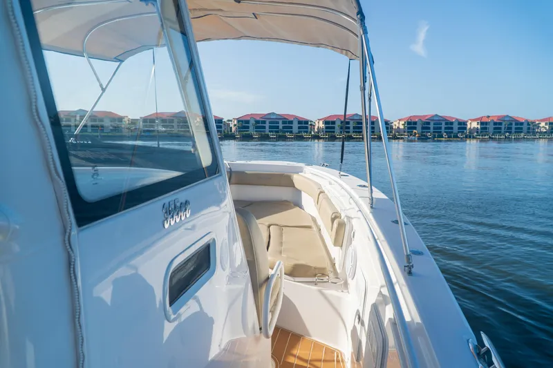 Slide: The Image of 2019 Everglades 355 Center Console boat on calm water with waterfront buildings in the background. - 6