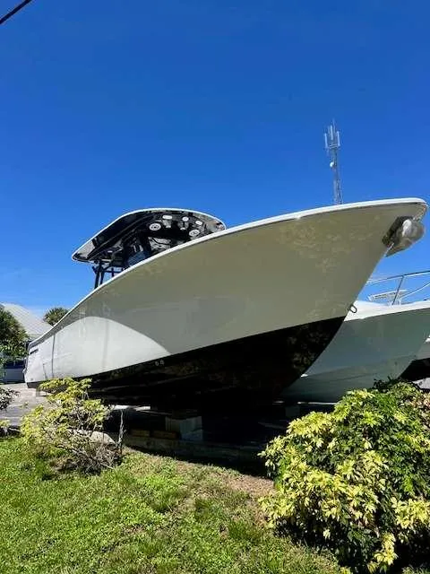 Slide: The Image of 2025 Sportsman 282 Open boat on display under clear blue sky. - 1