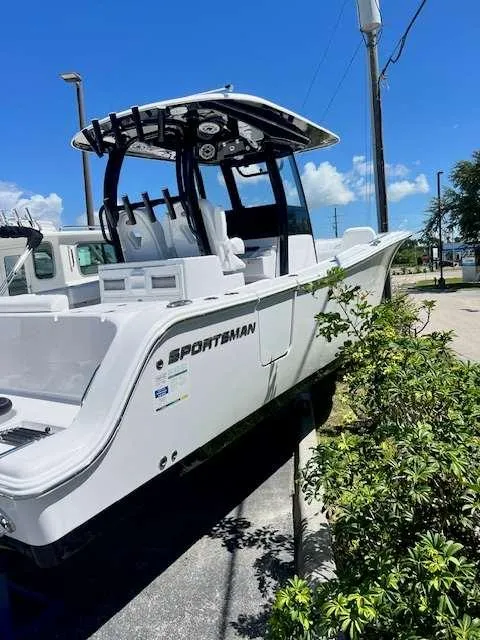Slide: The Image of 2025 Sportsman 282 Open boat on display outdoors. - 2