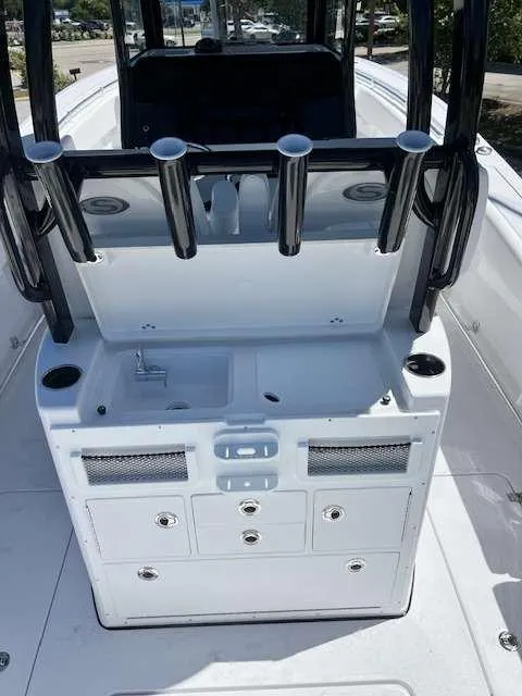 Slide: The Image of 2025 Sportsman 282 Open boat center console with rod holders and storage compartments. - 5