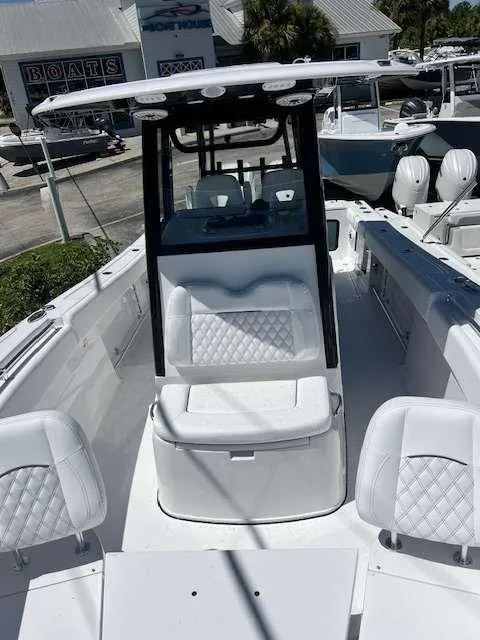 Slide: The Image of 2025 Sportsman 282 Open boat interior with white seating and console. - 7