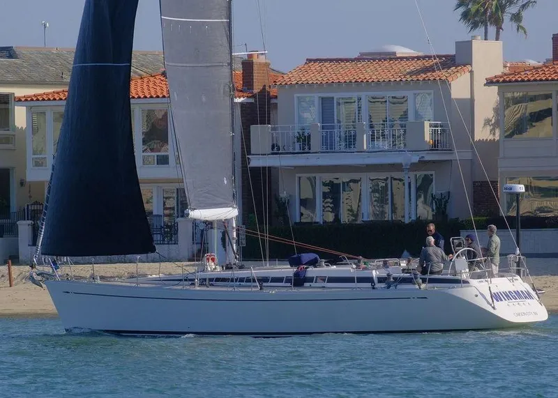 Slide: The Image of 2001 Nautor Swan 48 sailboat docked near waterfront homes. - 1