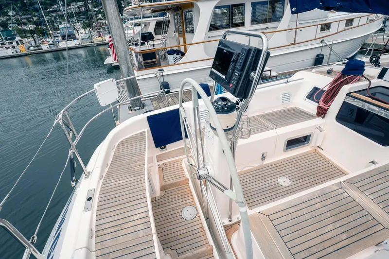 Slide: The Image of Nautor Swan 48 (2001) yacht cockpit with wooden deck, docked at marina. - 11