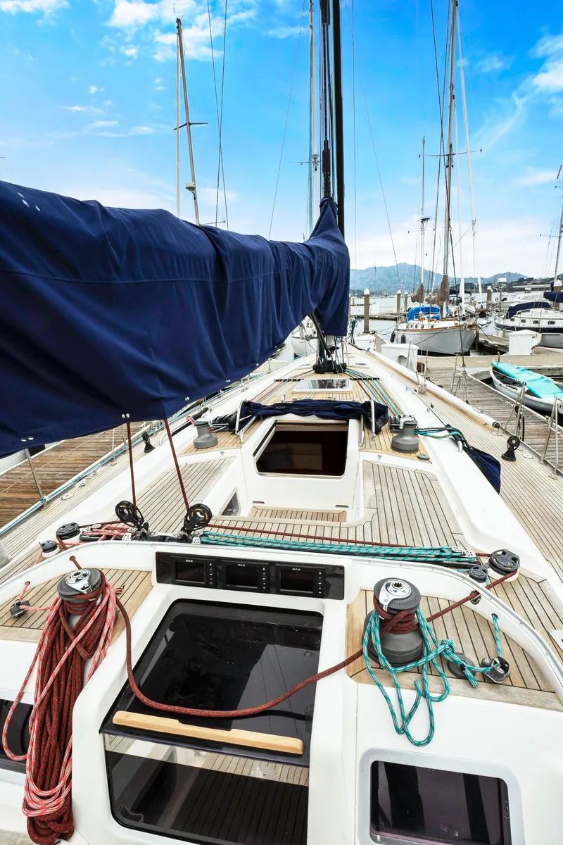 Slide: The Image of Nautor Swan 48 sailboat, 2001 model, docked at a marina with blue sky background. - 15
