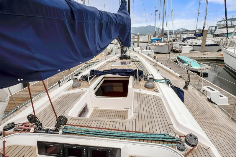 Slide: The Image of Nautor Swan 48 sailboat, 2001 model, docked at marina with open hatch and blue sail cover. - 18