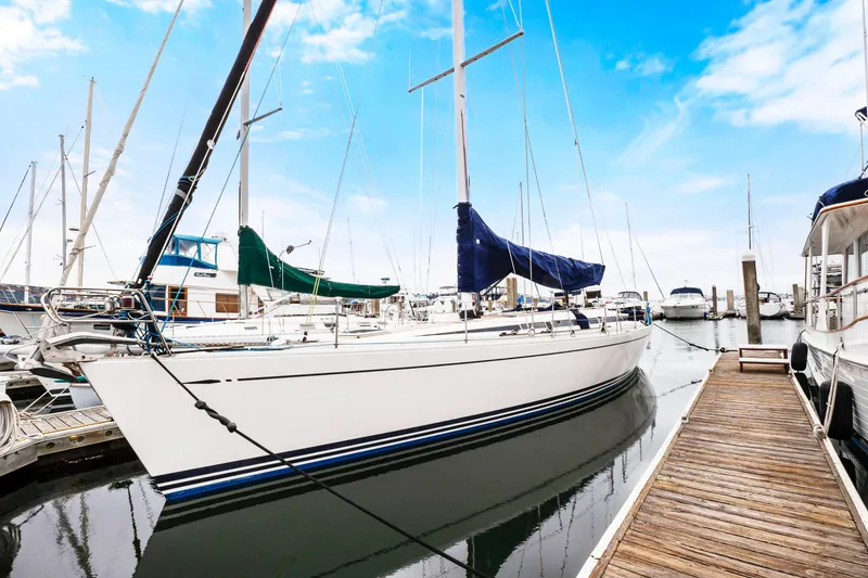 Slide: The Image of Nautor Swan 48 sailboat, 2001 model, docked at a marina with clear blue skies. - 2