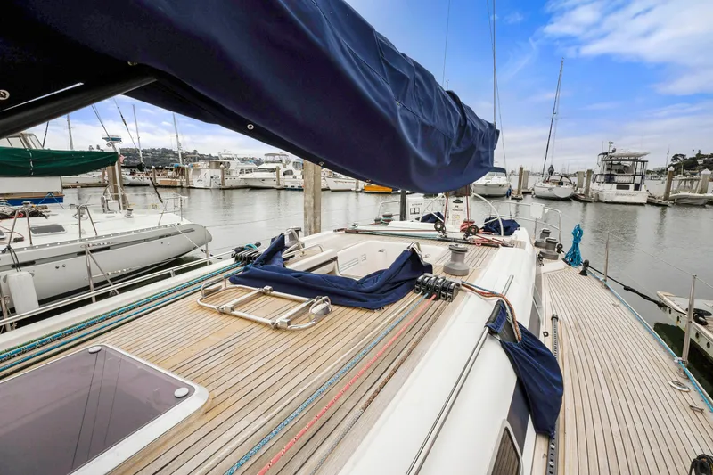 Slide: The Image of Nautor Swan 48 (2001) sailboat docked at a marina, showcasing its deck and rigging. - 21