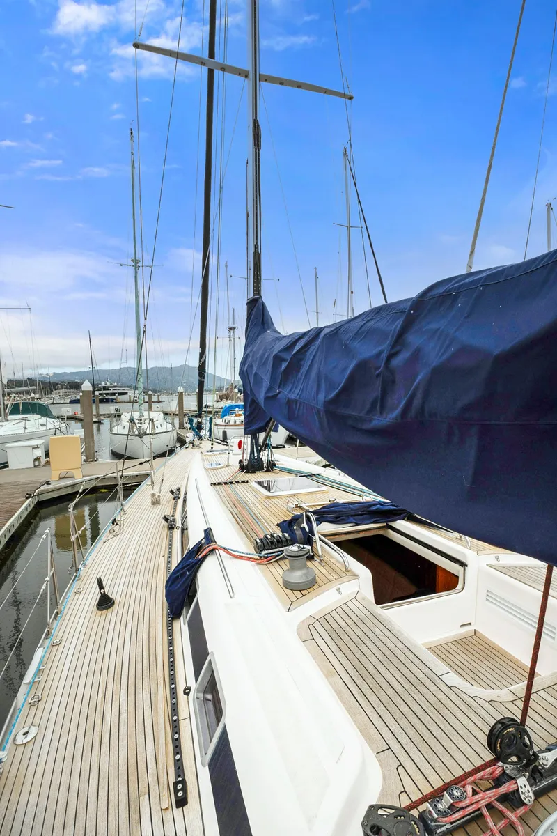 Slide: The Image of Nautor Swan 48 sailboat, 2001 model, docked at a marina with clear blue skies. - 23