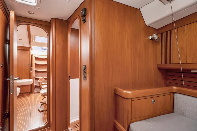 Slide: The Image of Interior of 2001 Nautor Swan 48 yacht with wooden finish and cozy seating area. - 25