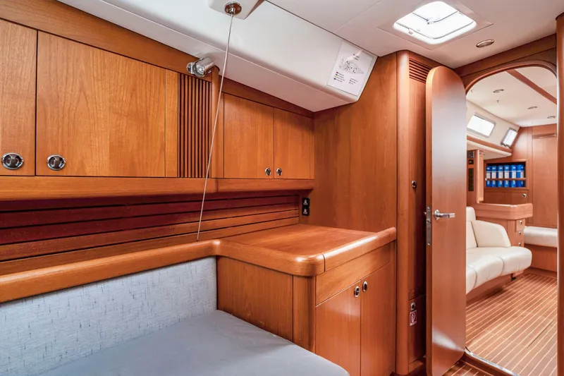 Slide: The Image of Interior of 2001 Nautor Swan 48 yacht with wooden cabinetry and seating area. - 26