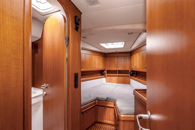 Slide: The Image of Luxurious wooden cabin interior of 2001 Nautor Swan 48 yacht with cozy bed. - 27