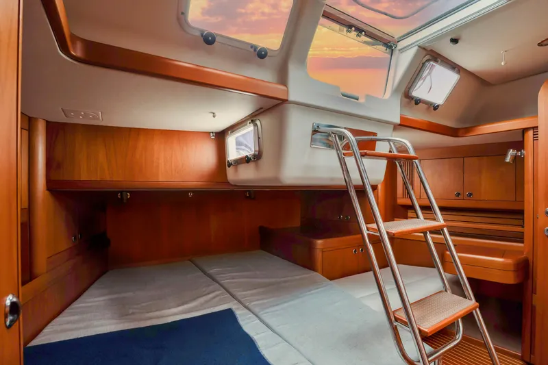 Slide: The Image of Interior cabin of 2001 Nautor Swan 48 sailboat with wooden finish and ladder. - 30