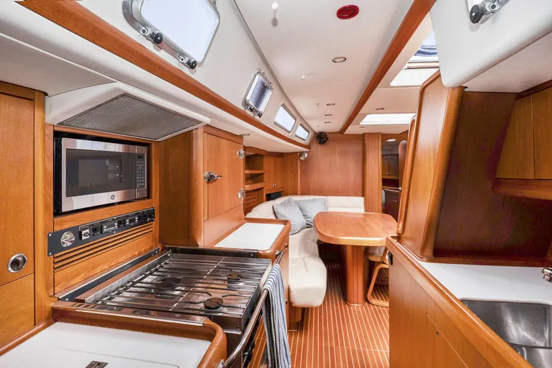 Slide: The Image of Interior of 2001 Nautor Swan 48 yacht with modern kitchen and dining area. - 34