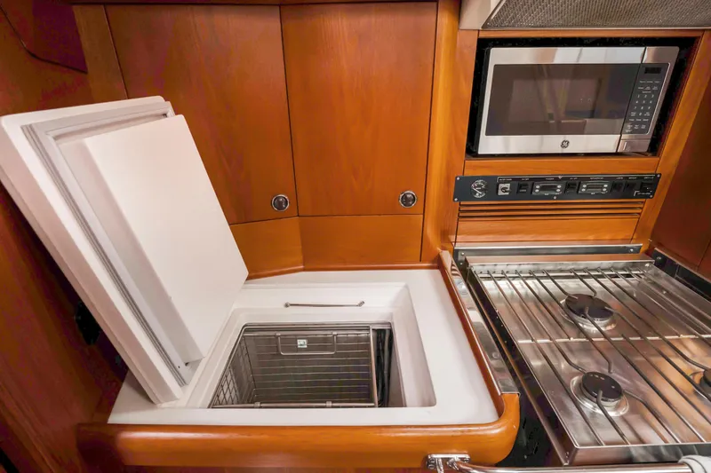 Slide: The Image of Nautor Swan 48 yacht kitchen, 2001 model, featuring stove, microwave, and built-in refrigerator. - 35