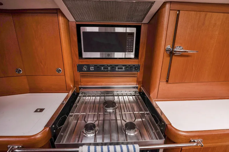 Slide: The Image of Nautor Swan 48 yacht kitchen with stove, microwave, and wooden cabinetry, 2001 model. - 39