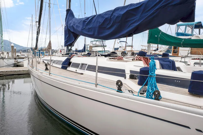 Slide: The Image of 2001 Nautor Swan 48 sailboat docked in a marina. - 4