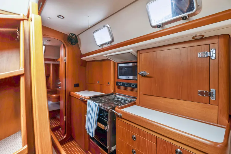 Slide: The Image of Nautor Swan 48 2001 yacht interior kitchen with wooden cabinetry and modern appliances. - 40