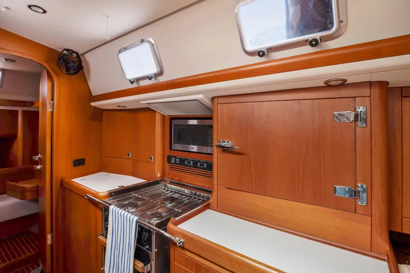 Slide: The Image of Nautor Swan 48 yacht kitchen interior, 2001 model, featuring wooden cabinetry and modern appliances. - 41