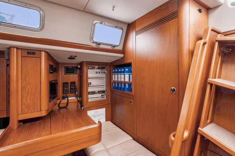 Slide: The Image of Interior of a 2001 Nautor Swan 48 yacht with wooden cabinetry and navigation equipment. - 45