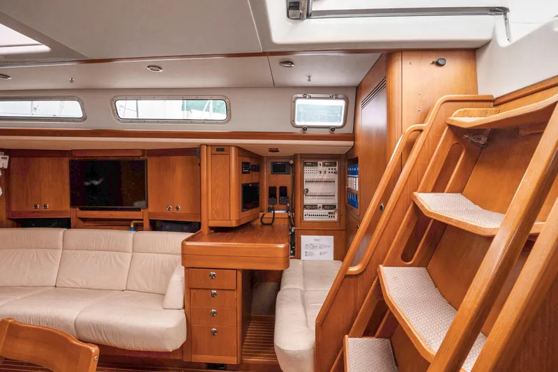 Slide: The Image of Interior of 2001 Nautor Swan 48 yacht with wooden cabinetry and beige seating. - 47
