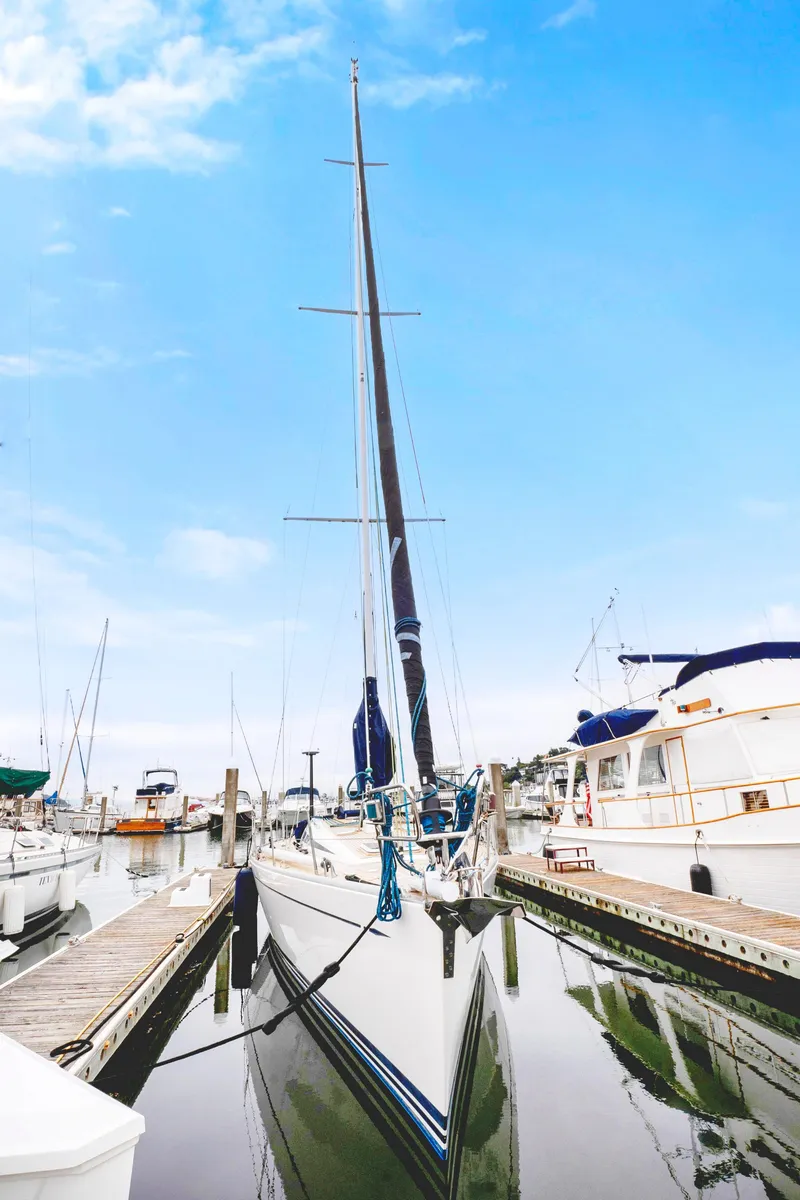Slide: The Image of Nautor Swan 48 sailboat, 2001 model, docked at marina under clear blue sky. - 9