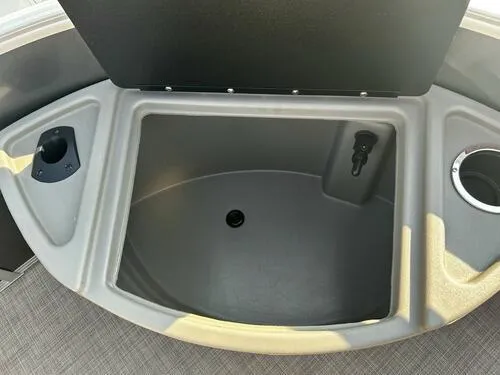 Slide: The Image of Sun Tracker Fishin' Barge 22 XP3 2025 storage compartment with cup holders. - 11