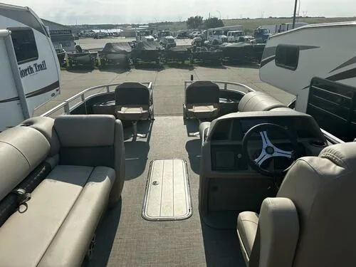 Slide: The Image of 2025 Sun Tracker Fishin' Barge 22 XP3 interior with seating and steering console. - 6
