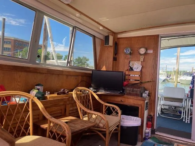 Slide: The Image of Interior of 1986 Silverton 37 Convertible boat with wooden furnishings and marina view. - 10