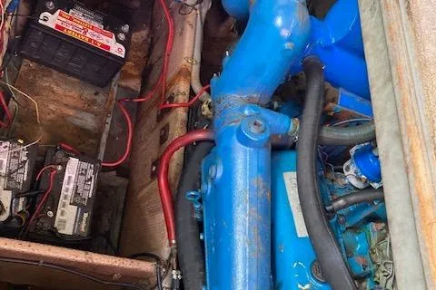 Slide: The Image of Engine compartment of a 1986 Silverton 37 Convertible with visible batteries and blue engine components. - 15