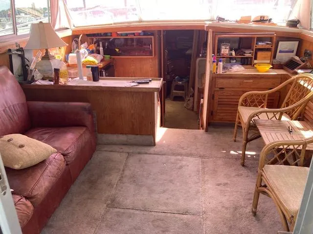Slide: The Image of Interior of a 1986 Silverton 37 Convertible boat with seating and wooden furnishings. - 7