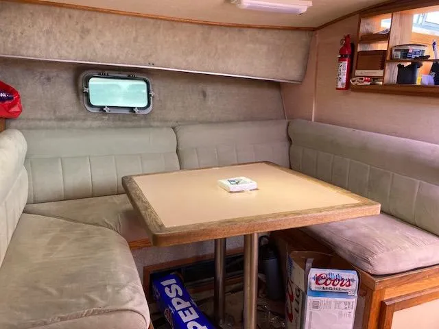 Slide: The Image of Interior of 1986 Silverton 37 Convertible with beige seating and dining table. - 9
