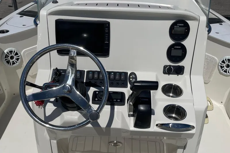 Slide: The Image of 2020 Stingray 206 CC boat dashboard with steering wheel and control panel. - 5